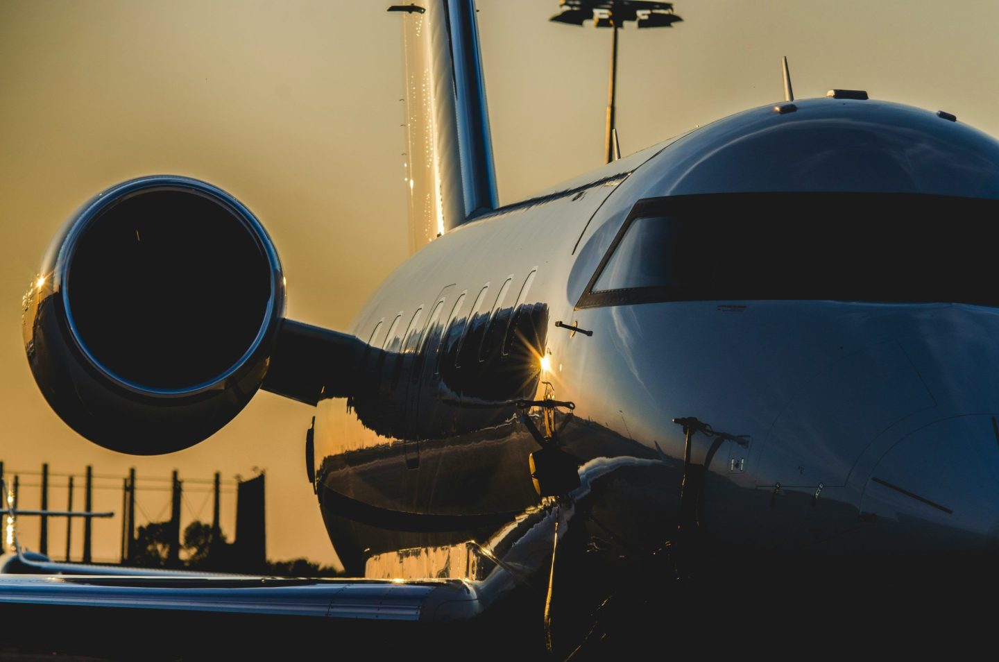 Private jet parked on the runway at sunset